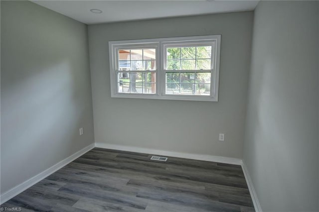 714 Martin St, Greensboro, NC 27406 - spare room featuring baseboards, visible vents, and dark wood-style floors