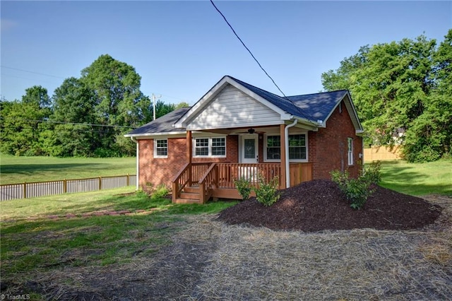 714 Martin St, Greensboro, NC 27406 - back of house featuring fence, covered porch, a yard, and brick siding