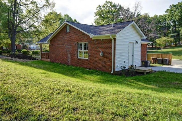 714 Martin St, Greensboro, NC 27406 - view of side of property featuring roof with shingles, a yard, and brick siding