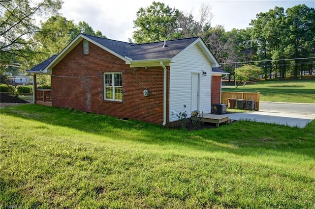 714 Martin St, Greensboro, NC 27406 - view of property exterior with a lawn, brick siding, and a shingled roof