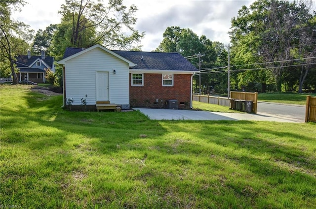 714 Martin St, Greensboro, NC 27406 - rear view of property featuring a lawn, central air condition unit, crawl space, and brick siding