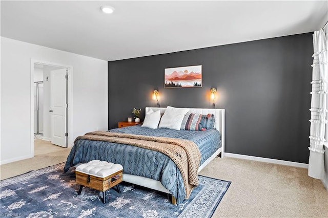 carpeted bedroom with baseboards and an accent wall