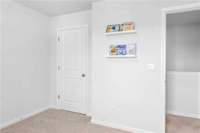 unfurnished bedroom with baseboards, carpet, and a closet