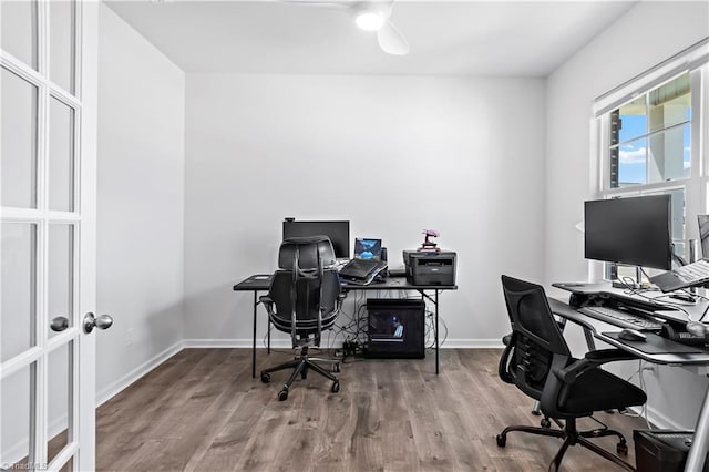 office area with baseboards, a ceiling fan, and wood finished floors