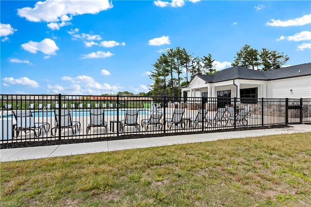 pool with a yard and fence