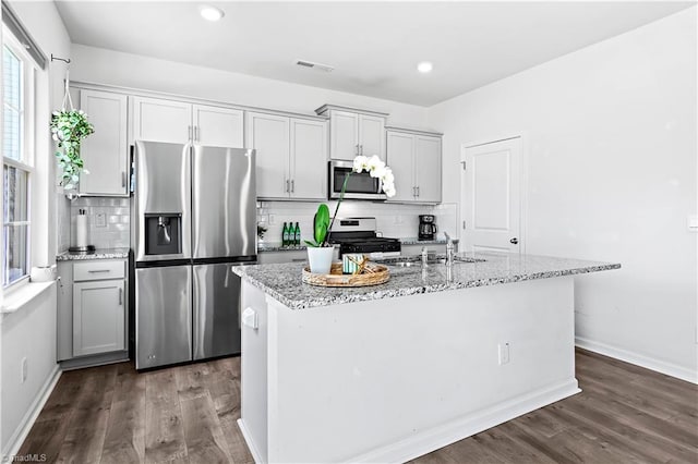kitchen featuring dark wood-style flooring, appliances with stainless steel finishes, a sink, and visible vents