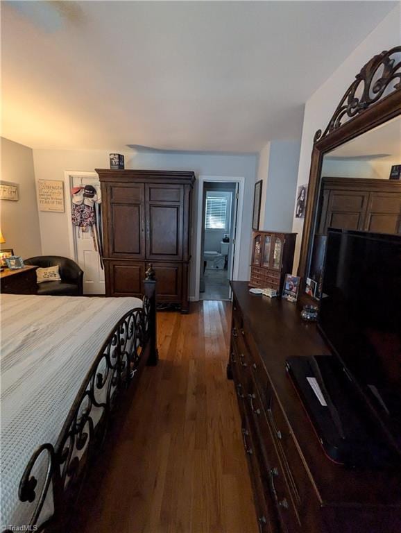 bedroom with dark hardwood / wood-style floors