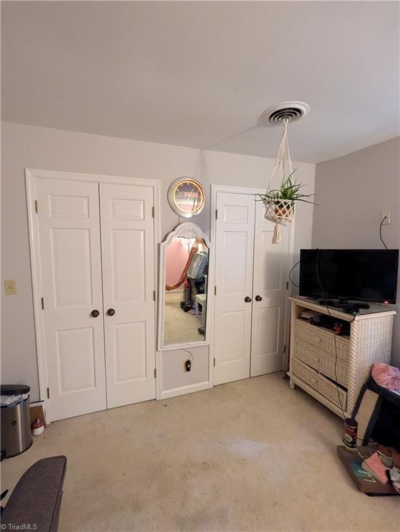 bedroom featuring light carpet