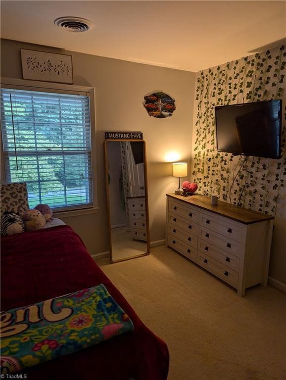 bedroom featuring light colored carpet