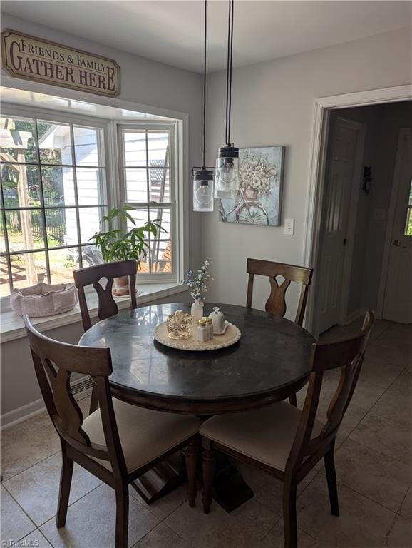 dining space featuring light tile patterned flooring