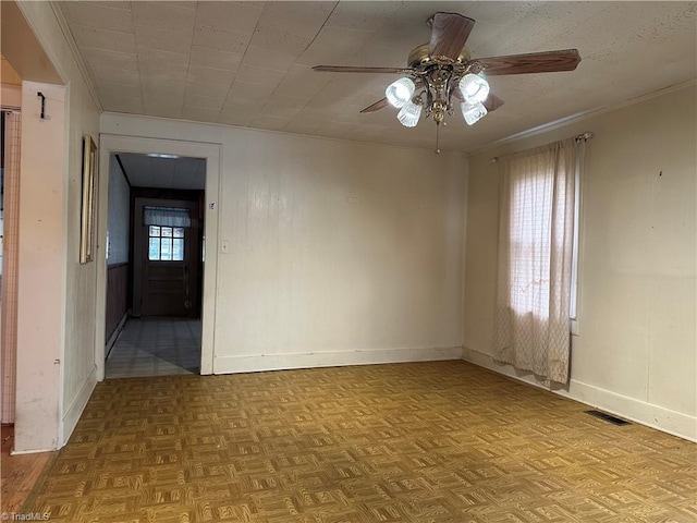 unfurnished room featuring ceiling fan, light parquet floors, and a healthy amount of sunlight