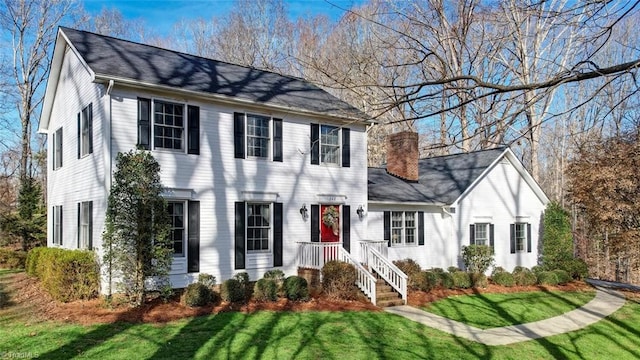 colonial home with a front lawn