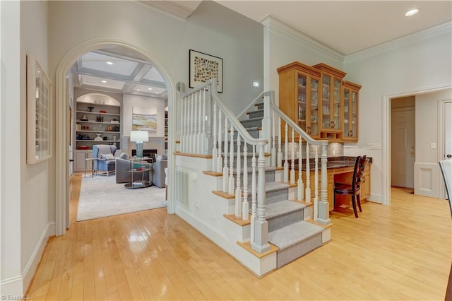10 Sunfish Pt, Greensboro, NC 27455 - stairway with arched walkways, wood-type flooring, ornamental molding, built in features, and recessed lighting