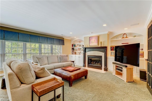 10 Sunfish Pt, Greensboro, NC 27455 - carpeted living area with built in features, a glass covered fireplace, crown molding, and recessed lighting