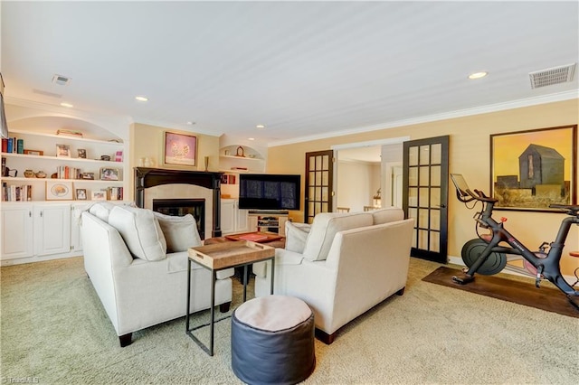 10 Sunfish Pt, Greensboro, NC 27455 - living area with ornamental molding, a glass covered fireplace, light colored carpet, french doors, and recessed lighting