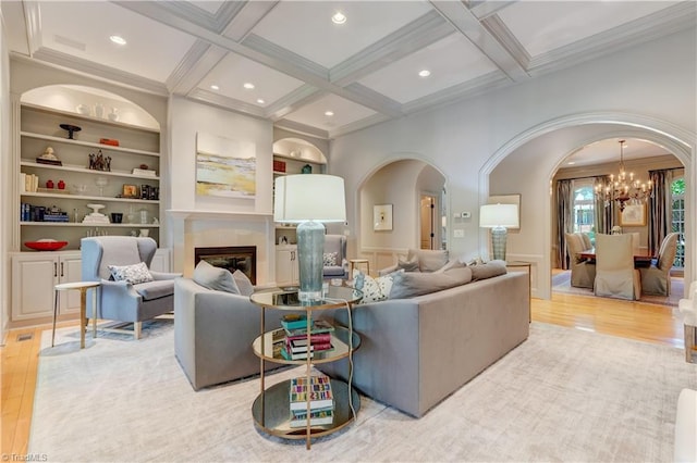 10 Sunfish Pt, Greensboro, NC 27455 - living area featuring arched walkways, wood finished floors, coffered ceiling, ornamental molding, and built in shelves