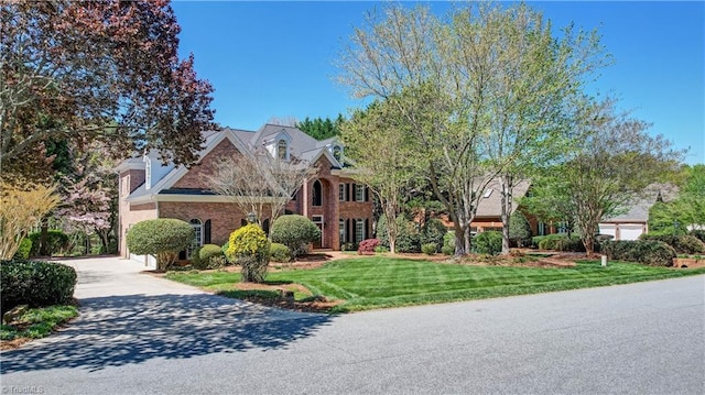 10 Sunfish Pt, Greensboro, NC 27455 - view of front of house with a front lawn, brick siding, and driveway