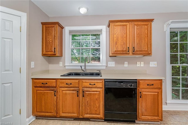 4335 Clovelly Dr, Greensboro, NC 27406 - kitchen with black dishwasher, light countertops, and brown cabinetry