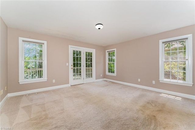4335 Clovelly Dr, Greensboro, NC 27406 - unfurnished room featuring baseboards and light colored carpet