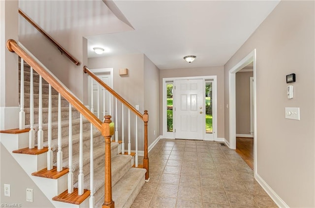 4335 Clovelly Dr, Greensboro, NC 27406 - entryway featuring baseboards and stairs