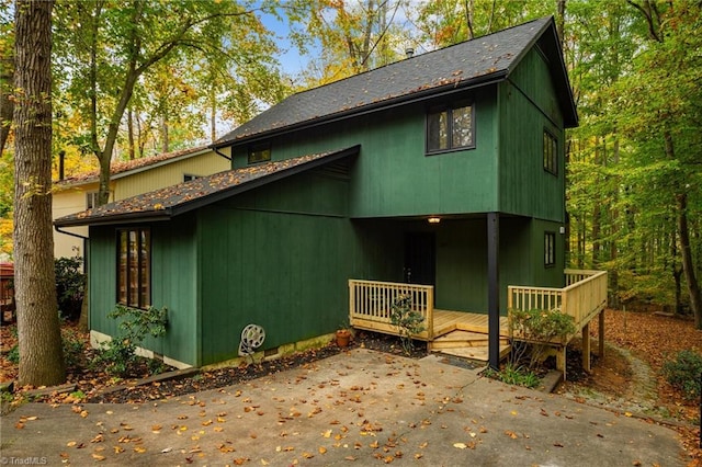 view of side of property featuring a wooden deck