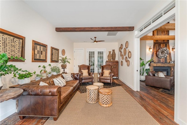 2733 Nebo Rd, East Bend, NC 27018 - living room featuring wood finished floors, beamed ceiling, a ceiling fan, and a fireplace