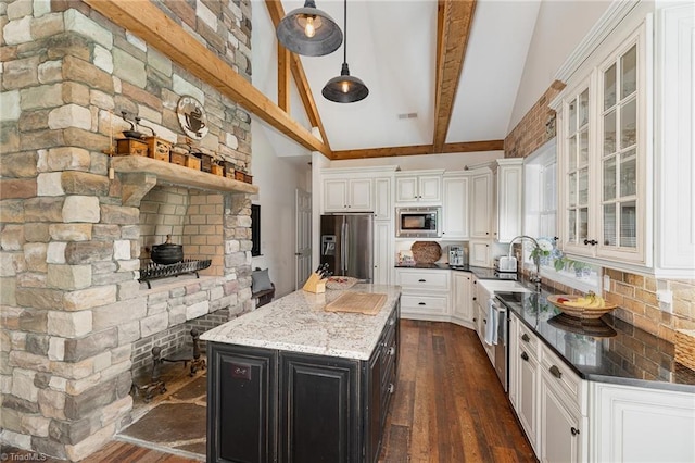 2733 Nebo Rd, East Bend, NC 27018 - kitchen featuring stainless steel appliances, beam ceiling, dark wood finished floors, glass insert cabinets, and white cabinetry