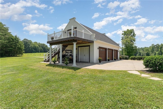2733 Nebo Rd, East Bend, NC 27018 - rear view of house with a wooden deck, stairway, a lawn, stucco siding, and concrete driveway