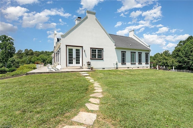 2733 Nebo Rd, East Bend, NC 27018 - rear view of house featuring french doors, a chimney, a lawn, stucco siding, and a patio