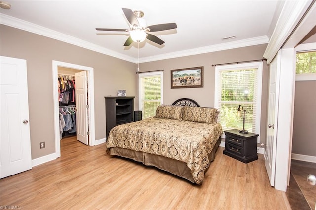 bedroom with multiple windows, light wood-type flooring, crown molding, and ceiling fan