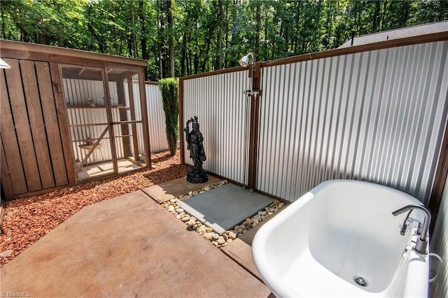 view of patio featuring a shed