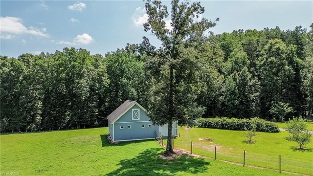 view of home's community featuring an outdoor structure and a lawn