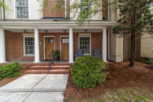 606 Bellemeade St, Greensboro, NC 27401 - entrance to property with brick siding, a porch, and stucco siding