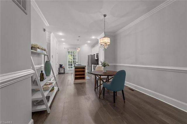 606 Bellemeade St, Greensboro, NC 27401 - dining area with crown molding, dark wood-style floors, recessed lighting, wine cooler, and a chandelier