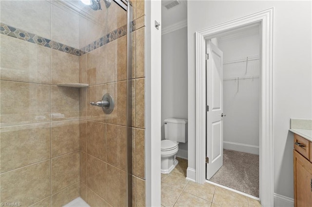 606 Bellemeade St, Greensboro, NC 27401 - full bath featuring a shower stall, vanity, a walk in closet, tile patterned flooring, and crown molding
