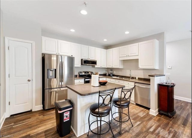 2431 Eagle Creek Ct Unit 203, Winston-Salem, NC 27103 - kitchen featuring stainless steel appliances, dark wood finished floors, white cabinetry, and a sink