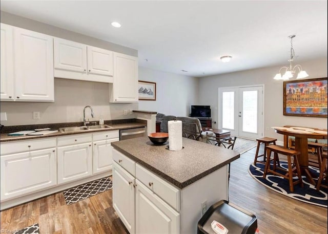 2431 Eagle Creek Ct Unit 203, Winston-Salem, NC 27103 - kitchen with wood finished floors, a sink, dishwasher, and dark countertops
