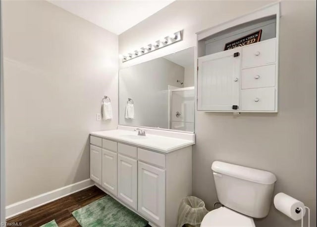 2431 Eagle Creek Ct Unit 203, Winston-Salem, NC 27103 - bathroom with vanity, toilet, baseboards, wood finished floors, and a shower with door