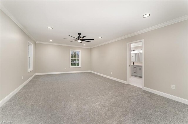 unfurnished room featuring ceiling fan, light colored carpet, and ornamental molding