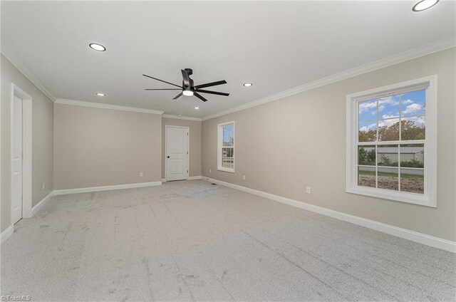 carpeted empty room featuring crown molding and ceiling fan