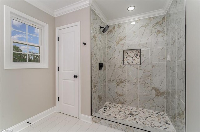 bathroom featuring a tile shower, crown molding, and tile patterned floors