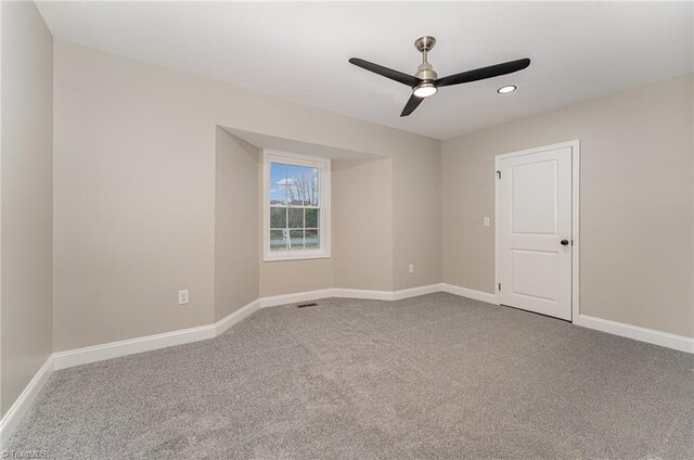 spare room with carpet flooring and ceiling fan