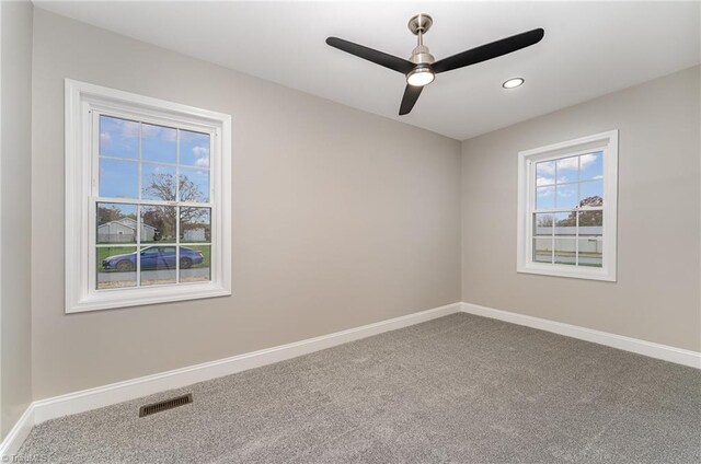 spare room featuring carpet flooring and ceiling fan