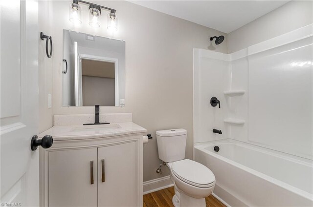 full bathroom with hardwood / wood-style floors, vanity, toilet, and shower / tub combination