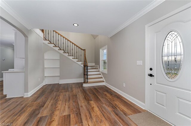 foyer featuring dark hardwood / wood-style floors and crown molding