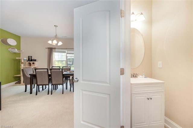 1720 Timber Cove Ct, Winston-Salem, NC 27127 - bathroom featuring vanity, baseboards, and a notable chandelier