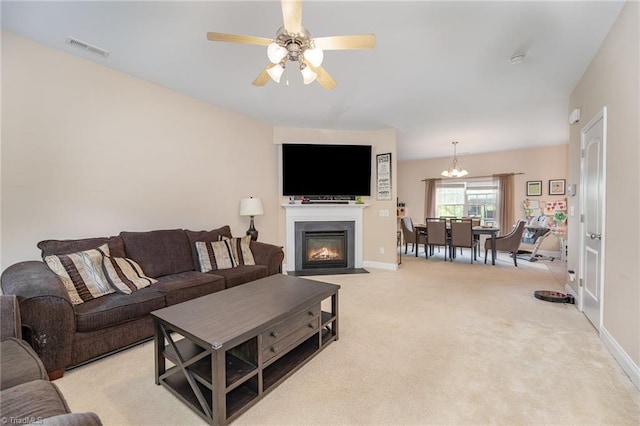1720 Timber Cove Ct, Winston-Salem, NC 27127 - living room with visible vents, light carpet, baseboards, a fireplace with flush hearth, and ceiling fan with notable chandelier