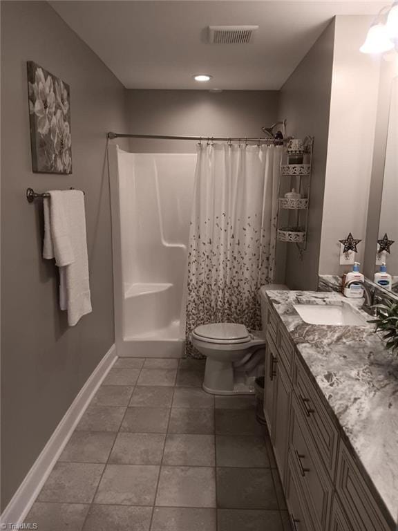 bathroom featuring tile patterned flooring, toilet, vanity, and a shower with shower curtain