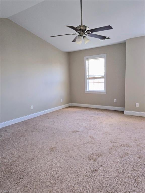 unfurnished room featuring light colored carpet, ceiling fan, and vaulted ceiling