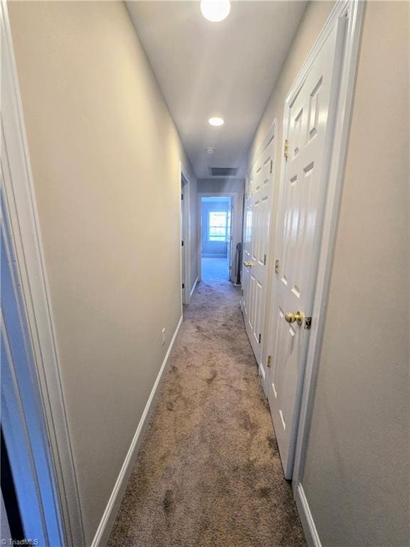 hallway with light colored carpet